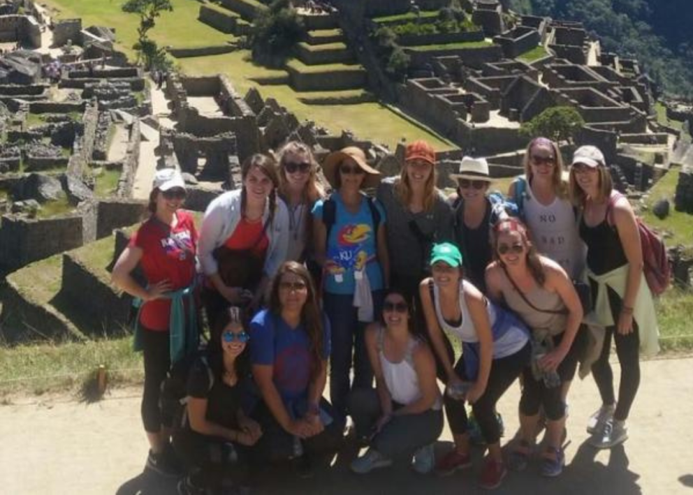 Students posing for a photo in front of Machu Picchu