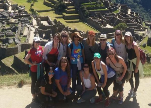 Students posing for a photo in front of Machu Picchu